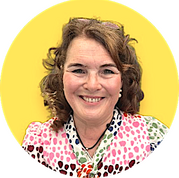 Photo of Dr Sharryn Gardner smiling on a yellow background, wearing a summer dress with multicolours